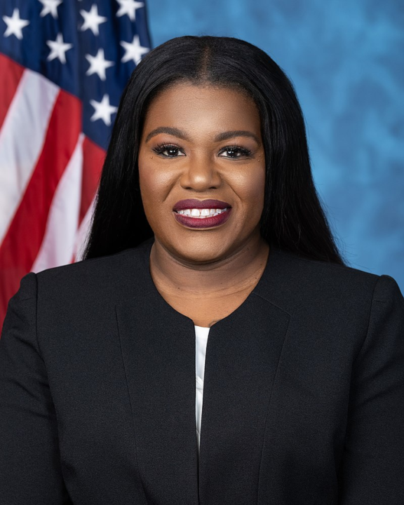 official portrait Congresswoman Cori Bush in suit in front of U.S. flag