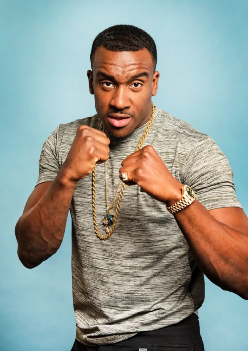 Bugzy Malone in a teeshirt, posing in a boxing stance