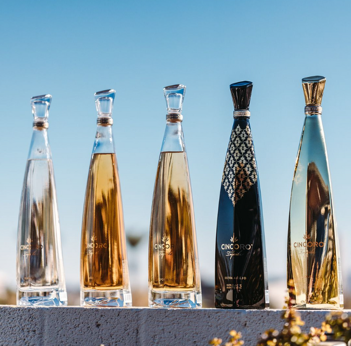 Cincoro tequila in elongated modern bottles with glass top