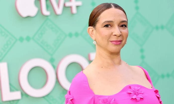 Maya Rudolph wearing pink dress and with hair in bun at an event