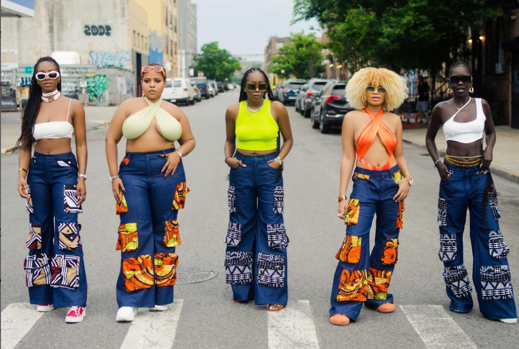 Black women of different shapes and sizes sporting jeans with Ankara print embellishments