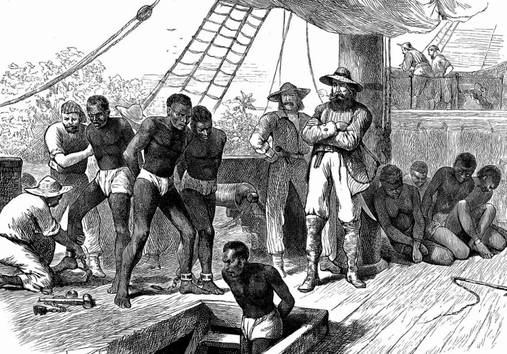 An 18th or 19th century engraving of white slave traders with tied up African slaves on a ship