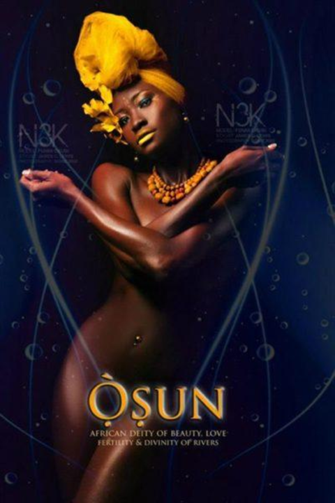 Depiction of Osun as a woman in headwrap and beaded necklace with a flower tucked behind the ear. Her arms are crossed over her chest.