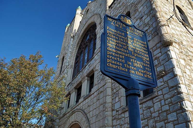 The old stone building of Mother Bethel AME Church, with a historic marker sign saying "Mother Bethel A.M.E. Church. Founded on ground purchased by Richard Allen in 1787, this congregation is the mother church of the African Methodist Episcopal denomination. The present structure, erected in 1889, replaces three earlier churches on this site."