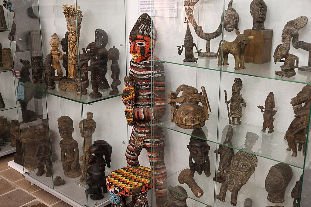 small African figures made of wood and natural materials in display case