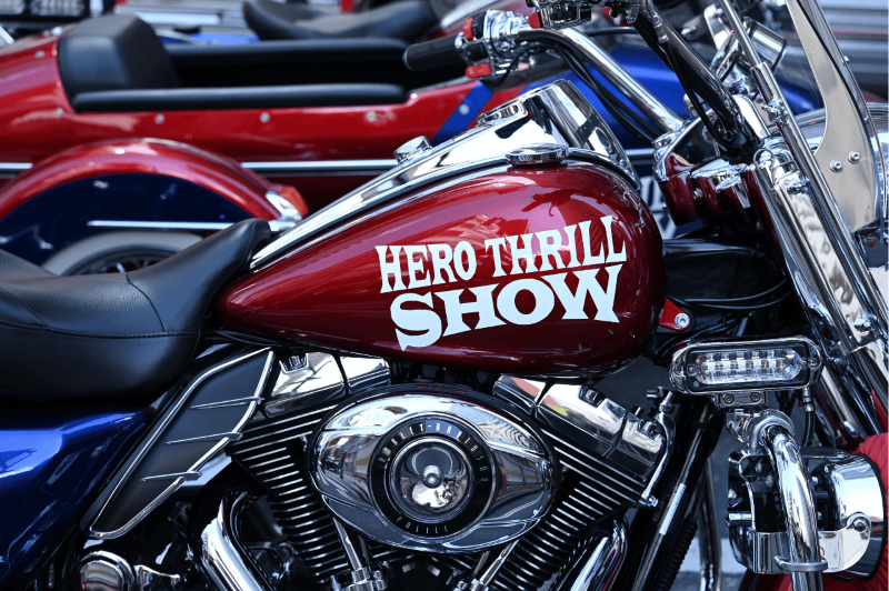 motorcycle with a sticker that says "Hero Thrill Show"