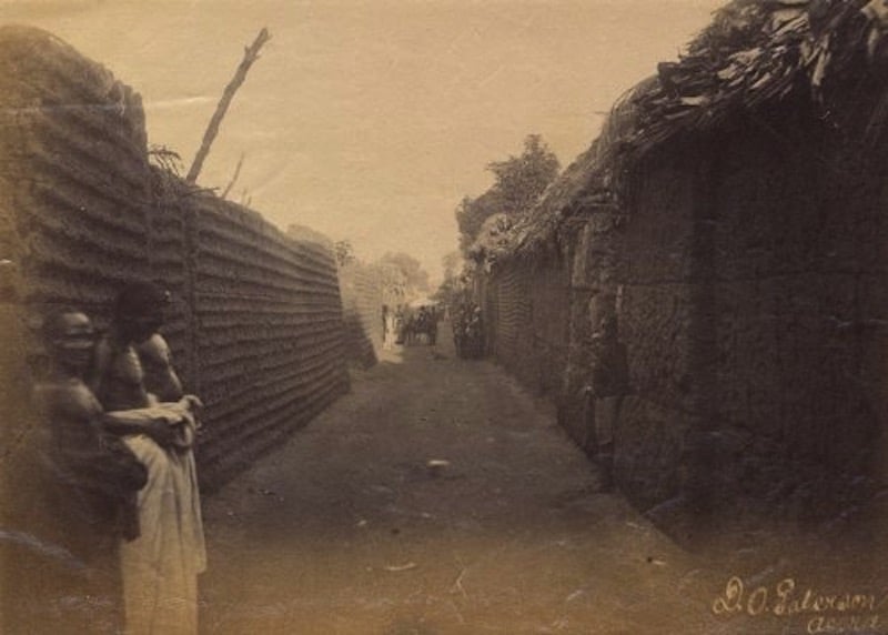 Silver gelatin print of Benin City wall with onlookers