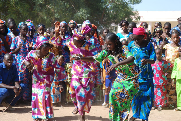 Kenyan women dancing in colorful dresses