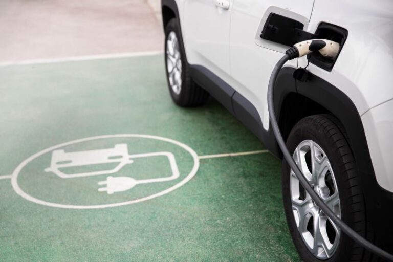 Electric car at a parking spot marked as charging station