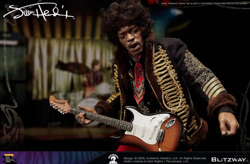 Jimi Hendrix holding guitar wearing a scarf, jacket with fur trim and gold embellishments. 