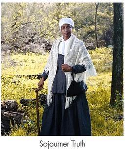 Black woman dressed as Sojourner Truth, in shawl, 19th century attire, and cane