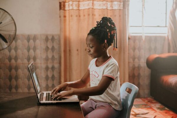 African girl using laptop at home