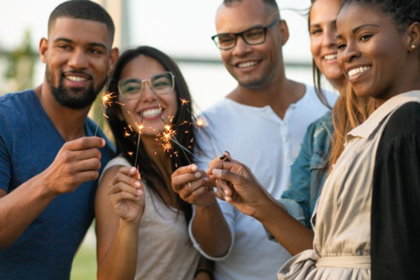 African American and other race friends celebrating with sparklers