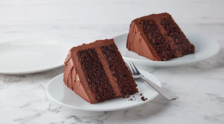 Two slices of chocolate cake on plates