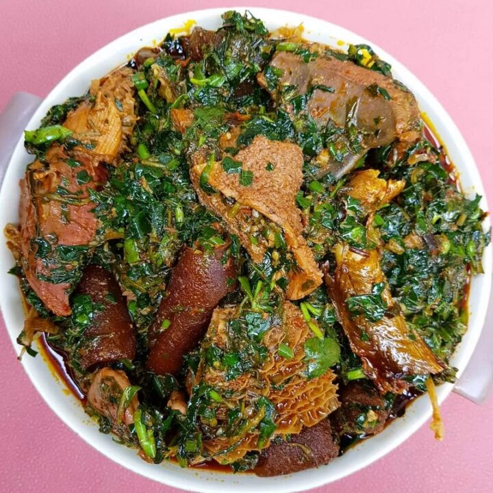 A stew of greens, and various meat, some resembling tripe.