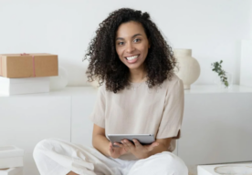 African American woman opening ipad and working