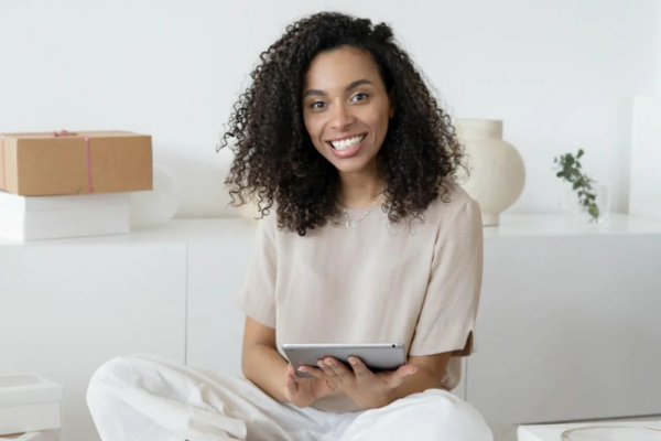 African American woman opening ipad and working