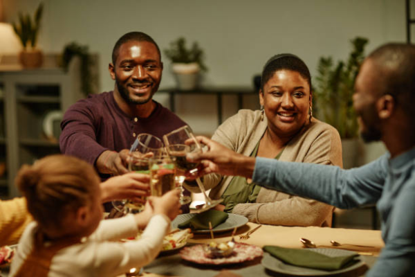 a group of Black friends and family toasting to the new year