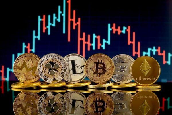 various cryptocurrency coins lined up in front of a stock chart
