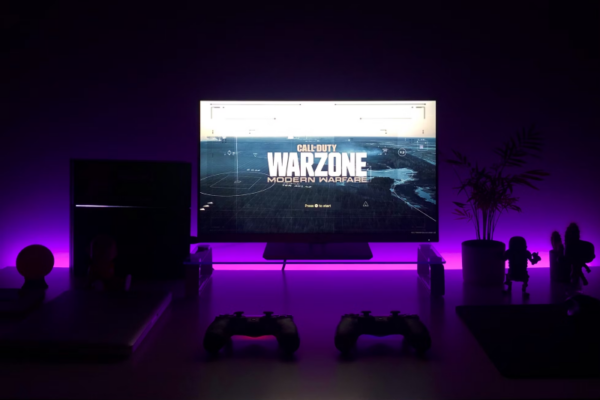 a gaming system in a dark room with Call of Duty Modern Warfare Warzone 3 on the screen