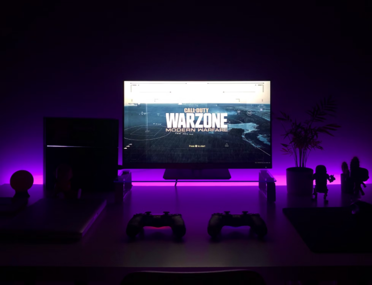 a gaming system in a dark room with Call of Duty Modern Warfare Warzone 3 on the screen