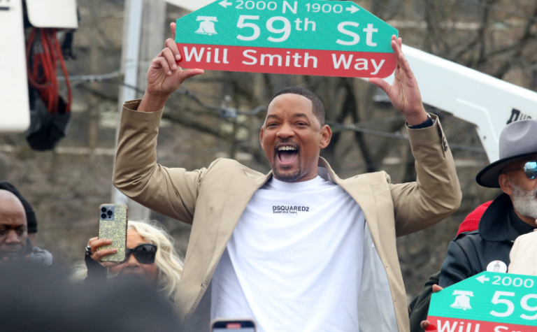 Actor Will Smith holding the sign for Will Smith Way