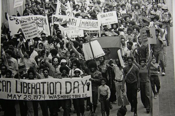 Why African Liberation Day Still Matters To Black People Worldwide Black and white photograph of people marching in Washington DC for African Liberation Day in 1974