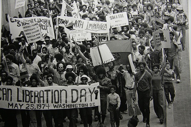 Why African Liberation Day Still Matters To Black People Worldwide Black and white photograph of people marching in Washington DC for African Liberation Day in 1974