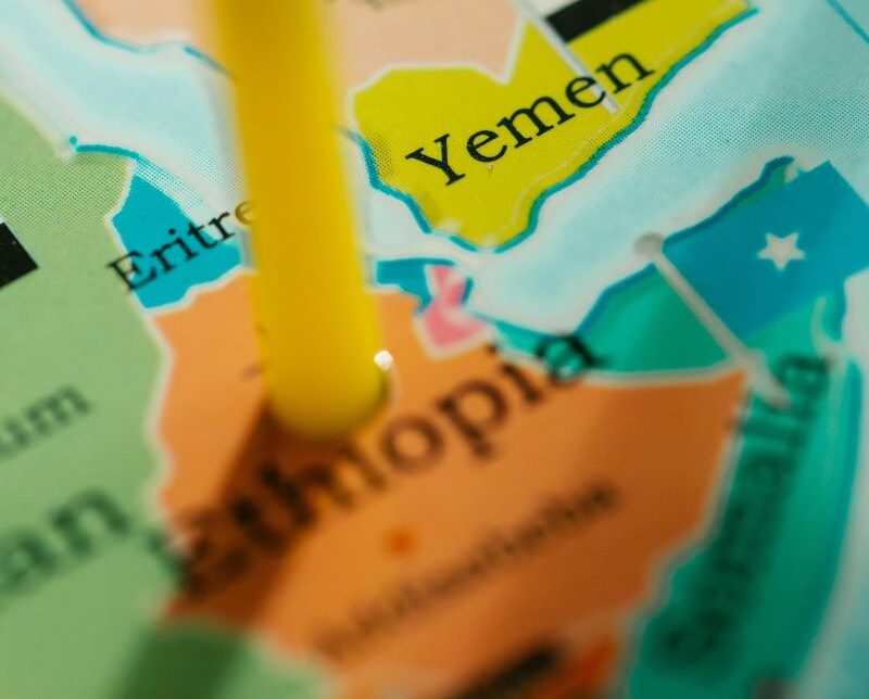 a pen pointing to Ethiopia on a world map