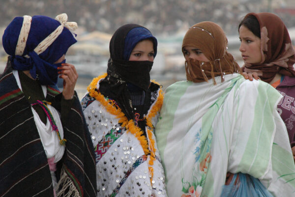 group of women in traditional attire and head and face coverings