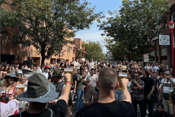 a crowd of people toasting and drinking beer outdoors at Philadelphia's Oktoberfest