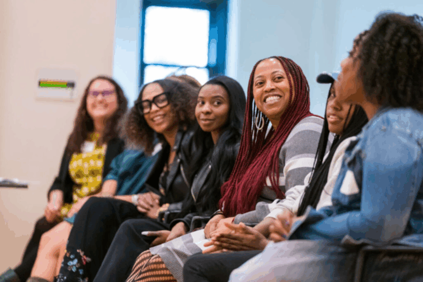 a group of mostly African American ladies having a discussion at the conference