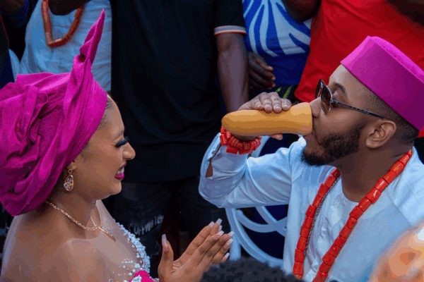 Igbo bride and groom, with the groom drinking palm wine from the Igba Nkwu cup