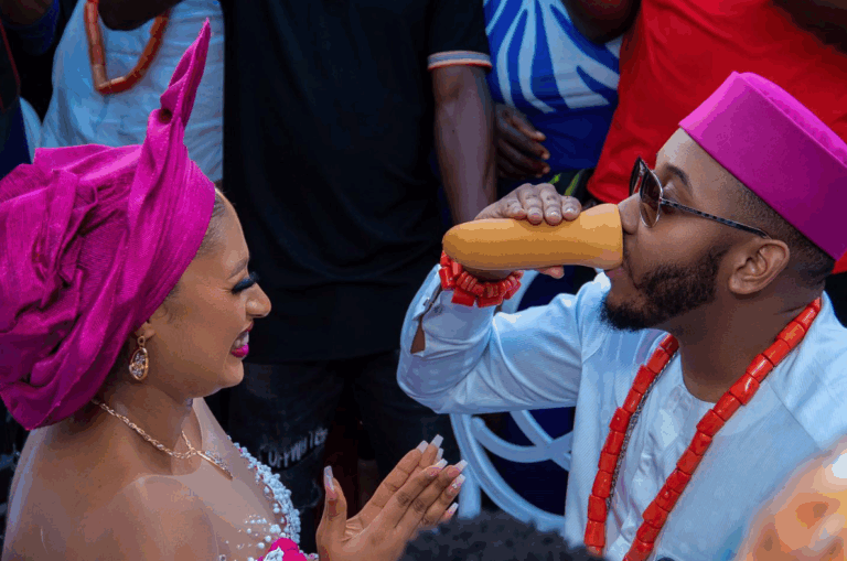 Igbo bride and groom, with the groom drinking palm wine from the Igba Nkwu cup