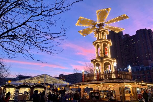 the 30 foot illuminated German Christmas tower, in shape of a windmill, against the Philadelphia sunset.