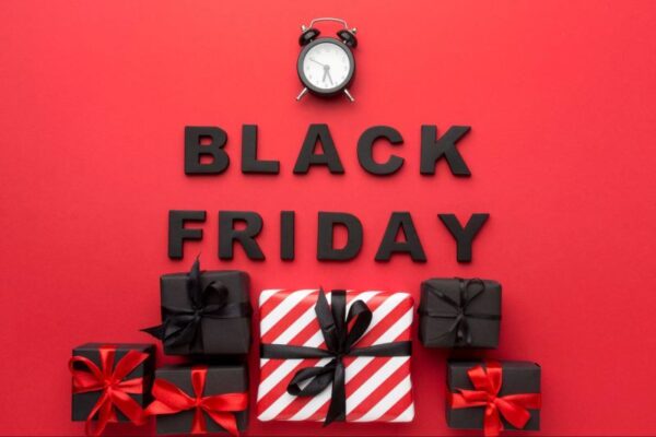 the text Black Friday with an alarm clock and wrapped presents