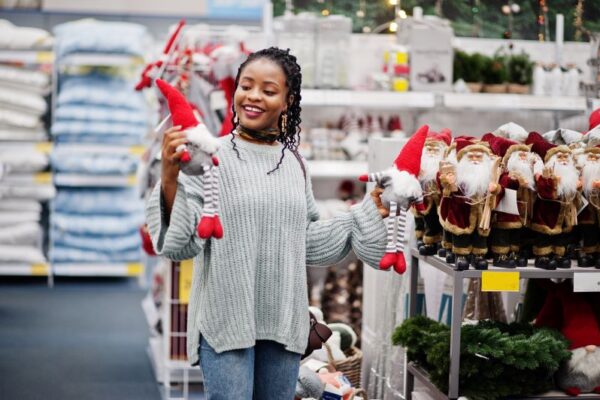 Black woman enjoying Christmas shopping at a home goods store