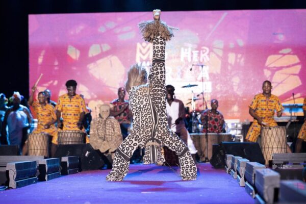 a performance by a traditional dancer doing a backflip and drummers at the Mother Africa Festival