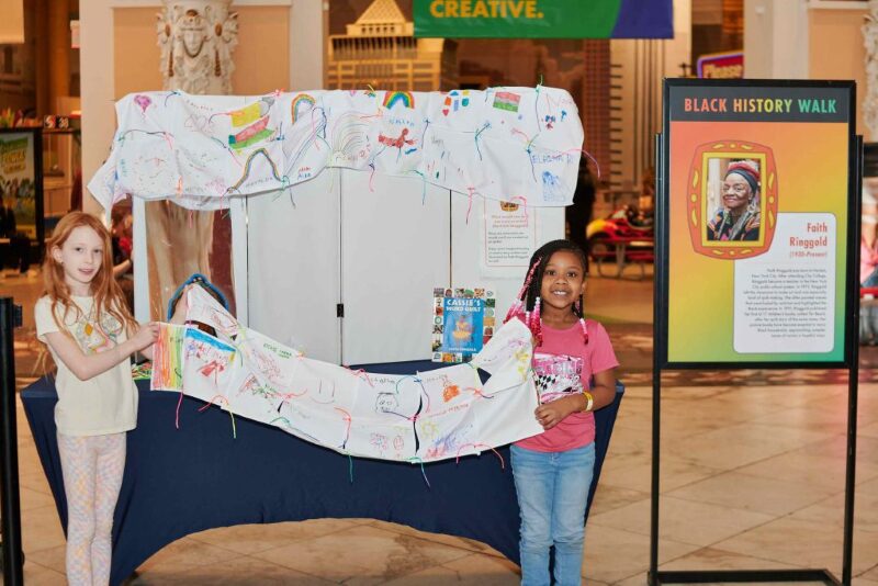 children at the Please Touch Museum holding artwork they made
