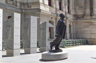 statue of Octavius Catto with arms outstretched and stepping forward