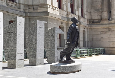statue of Octavius Catto with arms outstretched and stepping forward