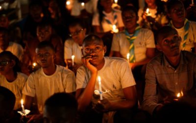 people holding candles for memorial services