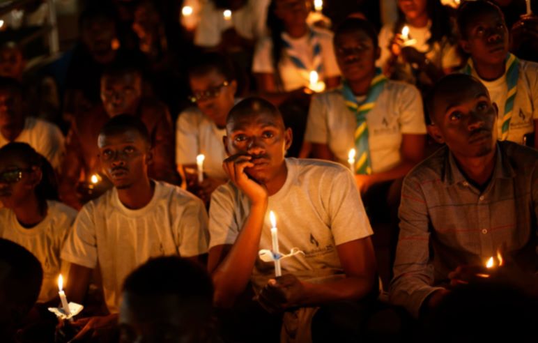 people holding candles for memorial services