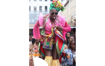 a costumed woman at a festival in shorts and a top embellished in frills