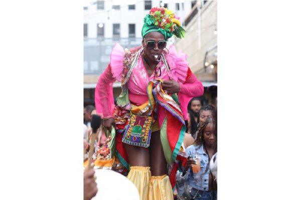 a costumed woman at a festival in shorts and a top embellished in frills