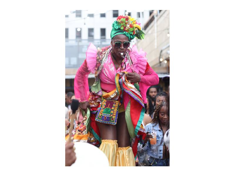 a costumed woman at a festival in shorts and a top embellished in frills
