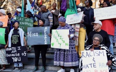 group of protestors, some in traditional attire, with slogans for Africans and anti-xenophobia