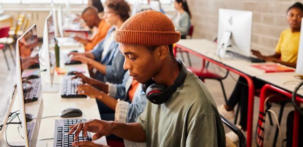 young African students working at computers in a classroom
