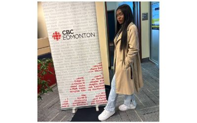 photo of Gift Wogu, in front of a banner that says CBC Edmonton