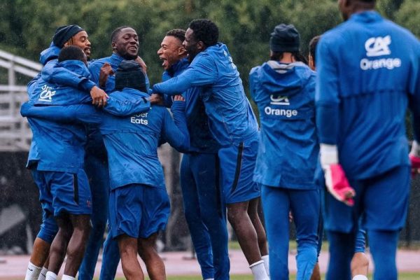 Kylian Mbappé of the France national team celebrating with teammates during a training session.